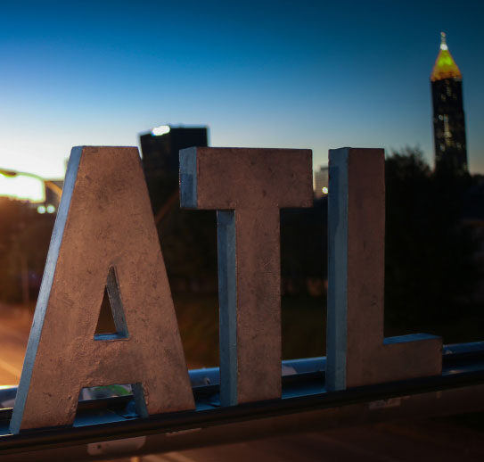 ATL letters with Atlanta skyline in background