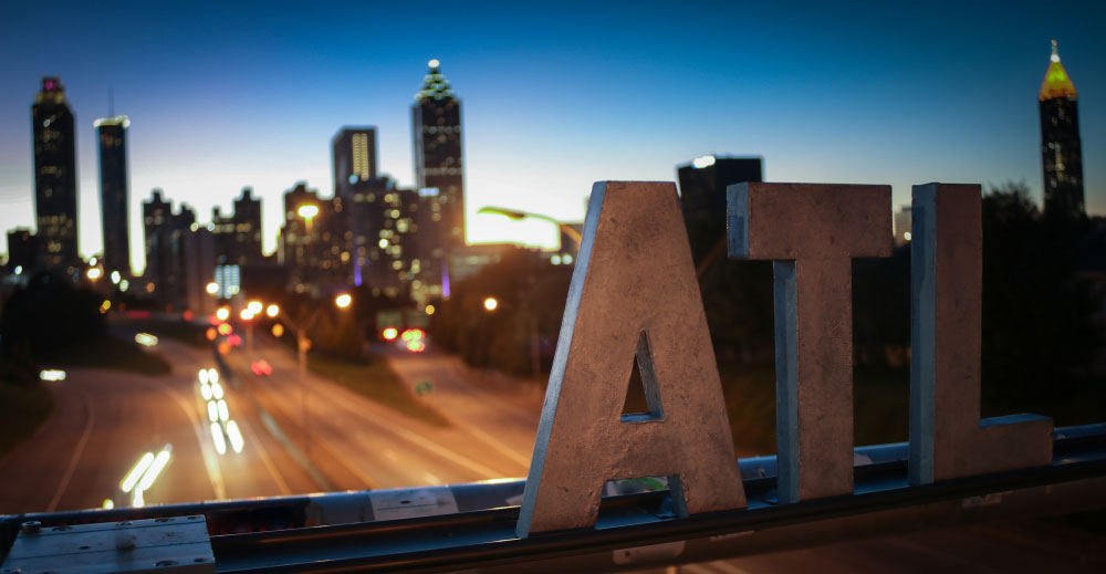 ATL letters with Atlanta skyline in background