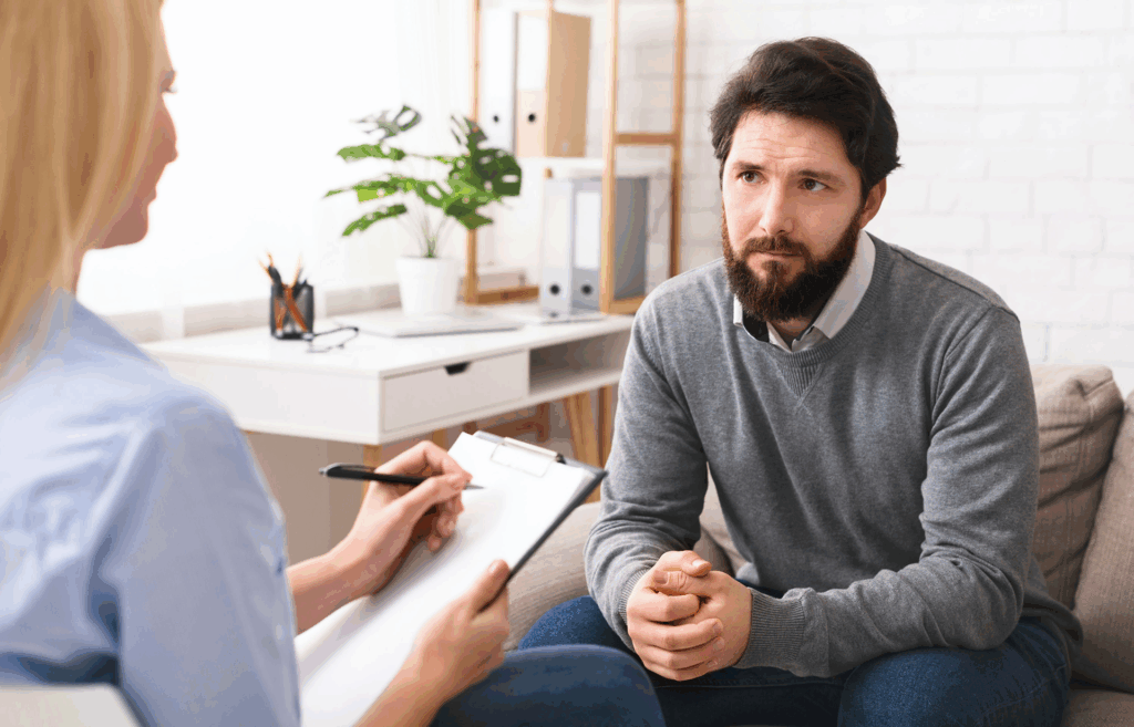 man speaking with medical professional about mixing xanax and alcohol