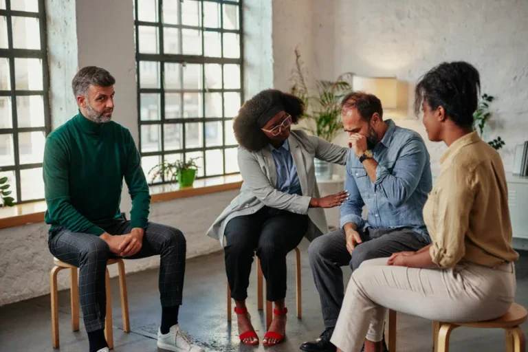 group of people in alcohol addiction rehab participating in a discussion