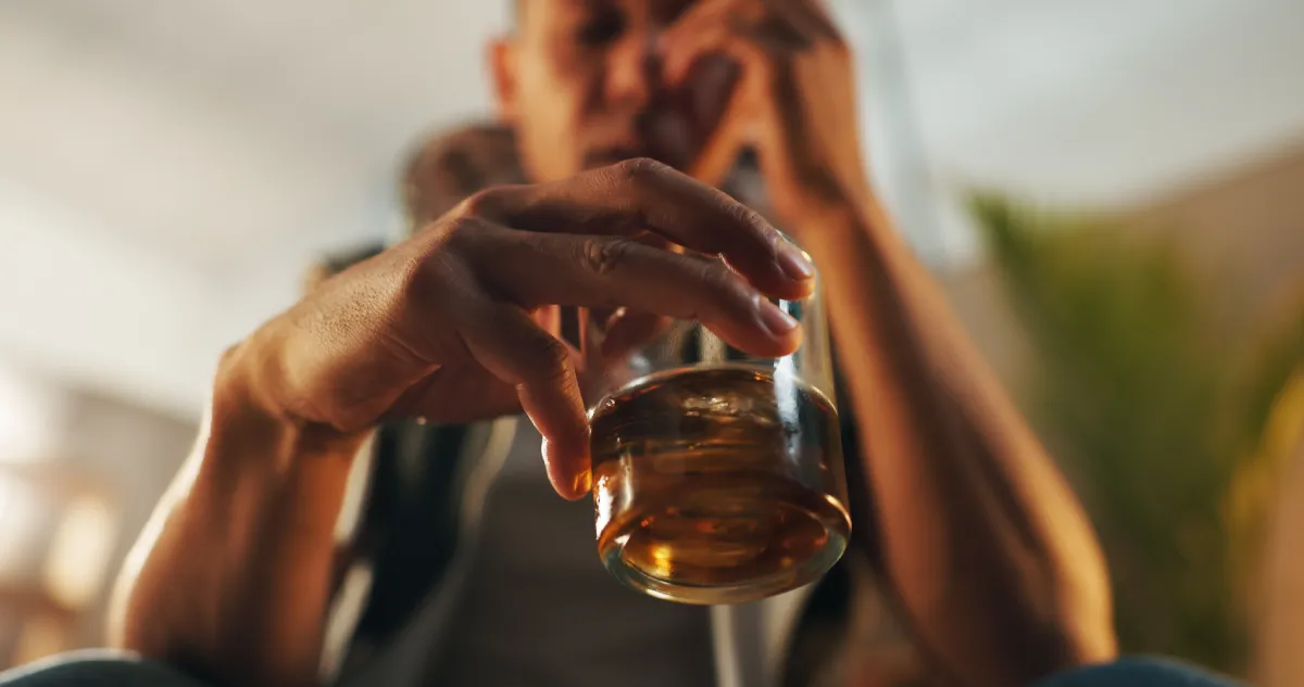 man-holding-glass-inside-with-contemplative-expres-2026-03-25-04-40-04-utc
