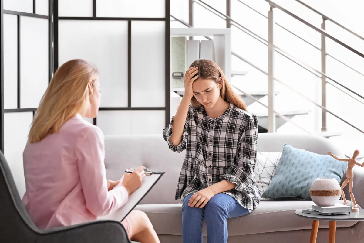 teenage-girl-consulting-therapist-in-bright-counse-2026-03-27-02-10-12-utc